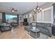 Cozy living room featuring a plush gray sectional sofa and updated light fixtures at 27173 N 86Th Ave, Peoria, AZ 85383