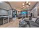 Open concept living room with a kitchen, dining room, and a sliding glass door at 27173 N 86Th Ave, Peoria, AZ 85383