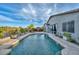 Backyard pool with adjacent patio and desert landscaping at 27173 N 86Th Ave, Peoria, AZ 85383
