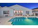 Backyard pool with patio seating area and white drapes at 27173 N 86Th Ave, Peoria, AZ 85383
