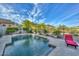 Sparkling pool with mature landscaping and beautiful desert backdrop at 27173 N 86Th Ave, Peoria, AZ 85383
