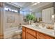 Bathroom with a tiled shower, a large mirror, and a wooden vanity at 2862 N 156Th Dr, Goodyear, AZ 85395
