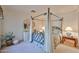 Bedroom featuring a four-poster bed, a dresser, and side tables with lamps at 2862 N 156Th Dr, Goodyear, AZ 85395