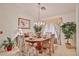 Bright dining room with a chandelier, floral drapes, and wood table at 2862 N 156Th Dr, Goodyear, AZ 85395