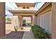 Inviting front entrance with an arched entryway, desert landscaping, and a pathway to the front door at 2862 N 156Th Dr, Goodyear, AZ 85395
