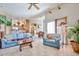Cozy living room with tile floors, comfortable seating, and access to the kitchen and dining area at 2862 N 156Th Dr, Goodyear, AZ 85395