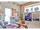 Comfortable living room with a stone fireplace, a large window, and a sliding glass door at 2862 N 156Th Dr, Goodyear, AZ 85395