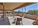 Covered patio featuring seating, a desert view, and access to the backyard and the surrounding community at 2862 N 156Th Dr, Goodyear, AZ 85395