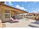 Covered patio with lounge chairs, tables, and a view of the backyard at 2862 N 156Th Dr, Goodyear, AZ 85395
