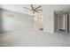 A large bedroom featuring neutral paint, plush carpet, and a modern ceiling fan at 31096 N 133Rd Ave, Peoria, AZ 85383