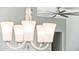 View of modern silver ceiling fan and a white glass chandelier at 31096 N 133Rd Ave, Peoria, AZ 85383