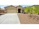 Charming single-story home featuring a well-manicured front yard and attached two-car garage at 31096 N 133Rd Ave, Peoria, AZ 85383
