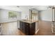 A kitchen island with granite countertops, stainless steel appliances, and dark wood cabinets at 31096 N 133Rd Ave, Peoria, AZ 85383