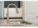 Close up of stainless steel sink with granite countertop and white subway tile backsplash at 31096 N 133Rd Ave, Peoria, AZ 85383
