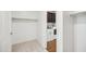 Organized walk-in closet with shelving and rods, with the laundry room visible through a doorway at 31096 N 133Rd Ave, Peoria, AZ 85383