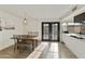 Bright dining room featuring a modern light fixture, a wood table, and French doors at 3324 S Juniper St, Tempe, AZ 85282