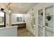Hallway leading to the bathroom with a built-in bookshelf and a dressing area at 3324 S Juniper St, Tempe, AZ 85282