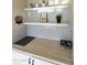 Stylish kitchen featuring white subway tile backsplash, wood countertops, and floating shelves, creating a modern workspace at 3324 S Juniper St, Tempe, AZ 85282