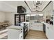 Well-lit kitchen featuring white cabinets, stainless steel appliances, subway tile backsplash, and black pendant lighting at 3324 S Juniper St, Tempe, AZ 85282