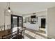 Bright kitchen and dining area with black French doors, white cabinets and countertops, and stainless-steel appliances at 3324 S Juniper St, Tempe, AZ 85282