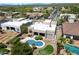 Aerial view showcasing a modern home with a kidney-shaped pool, lush landscaping, and outdoor living space at 4817 E Cielo Grande Ave, Phoenix, AZ 85054