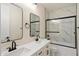 Bathroom featuring double sinks, white cabinets, and tiled shower at 4817 E Cielo Grande Ave, Phoenix, AZ 85054