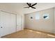 Bedroom with wood floors, closet, and natural light at 4817 E Cielo Grande Ave, Phoenix, AZ 85054