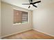 Cozy bedroom with neutral walls, wood floors, and natural light at 4817 E Cielo Grande Ave, Phoenix, AZ 85054