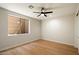 Bright bedroom with wood floors, neutral walls, and a large window at 4817 E Cielo Grande Ave, Phoenix, AZ 85054