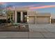 Charming single-story home featuring a landscaped front yard and a two-car garage with wooden beam accents at 4817 E Cielo Grande Ave, Phoenix, AZ 85054