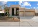 Charming single-story home featuring a landscaped front yard and a two-car garage with wooden beam accents at 4817 E Cielo Grande Ave, Phoenix, AZ 85054