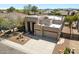 Exterior view showcasing a modern desert home with a three-car garage and desert landscaping at 4817 E Cielo Grande Ave, Phoenix, AZ 85054