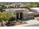 Modern home featuring desert landscaping, three-car garage, and neutral exterior colors at 4817 E Cielo Grande Ave, Phoenix, AZ 85054
