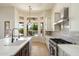 Bright modern kitchen with a view of the backyard pool and outdoor living space at 4817 E Cielo Grande Ave, Phoenix, AZ 85054