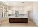 Modern kitchen with white cabinets, stainless steel appliances, and a dark wood island at 4817 E Cielo Grande Ave, Phoenix, AZ 85054