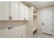 Laundry room with white cabinets and tile floors at 4817 E Cielo Grande Ave, Phoenix, AZ 85054