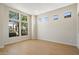Bright living room with large windows offering views of mature trees and tile flooring for low maintenance at 4817 E Cielo Grande Ave, Phoenix, AZ 85054