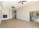 Spacious, bright living room with a fireplace and sliding glass door to the outdoor space at 4817 E Cielo Grande Ave, Phoenix, AZ 85054