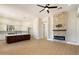 Bright open-concept living room and kitchen with a stacked stone fireplace at 4817 E Cielo Grande Ave, Phoenix, AZ 85054