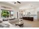 Bright open-concept living room and kitchen with a view of the outdoor pool at 4817 E Cielo Grande Ave, Phoenix, AZ 85054