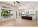 Bright open-concept living room and kitchen with tile floors at 4817 E Cielo Grande Ave, Phoenix, AZ 85054