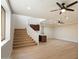 View of the stairs and spacious main living room with wood floors and a convenient wet bar at 4817 E Cielo Grande Ave, Phoenix, AZ 85054