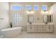 Luxurious main bathroom featuring a soaking tub, double vanities, and modern fixtures at 4817 E Cielo Grande Ave, Phoenix, AZ 85054