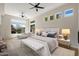Inviting main bedroom featuring many windows, a ceiling fan, and lots of natural light at 4817 E Cielo Grande Ave, Phoenix, AZ 85054
