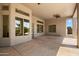 Spacious covered patio featuring ceiling fan and desert landscaping views through large windows at 4817 E Cielo Grande Ave, Phoenix, AZ 85054