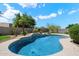 Inviting pool with tile accents and concrete surround, nestled within lush desert landscaping and a private backyard at 4817 E Cielo Grande Ave, Phoenix, AZ 85054