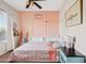 Stylish bedroom showcasing bed with floral bedding, pink accent wall and built in headboard shelving at 5320 W Fawn Dr, Laveen, AZ 85339