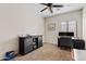 Versatile room with desk, black storage cabinet, ceiling fan, and neutral carpet at 5320 W Fawn Dr, Laveen, AZ 85339