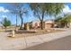 Charming single-story home featuring desert landscaping, an attached garage, and an inviting entrance at 5320 W Fawn Dr, Laveen, AZ 85339