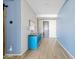 Bright entryway featuring a sleek blue cabinet, neutral walls, and modern lighting fixtures; adjacent to the front door at 5320 W Fawn Dr, Laveen, AZ 85339